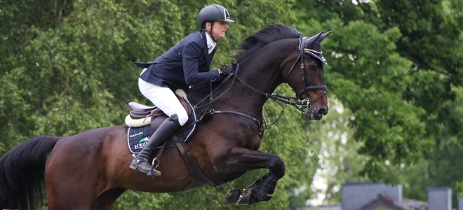 Nisse Lüneburg reitet auf seinem Pferd Calle Cool über den Wall beim HH Derby 2014